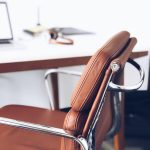 closeup photography of brown leather chair near white table