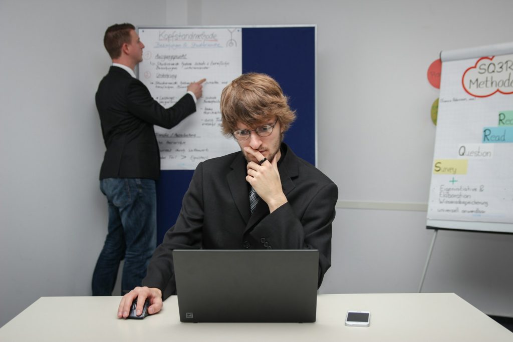 A woman sitting at a desk with a laptop computer