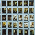 people inside high-rise building with concrete wall