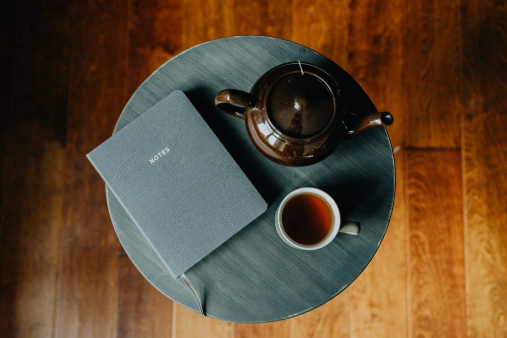 A cup of tea and a book on a table