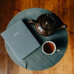 A cup of tea and a book on a table