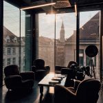 vacant sofa chairs beside glass window