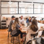 talking people sitting beside table