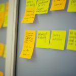 selective focus photography of yellow and orange post-it notes on wall