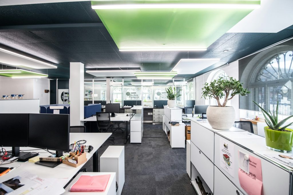 an office with white cabinets and desks