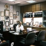 man in white dress shirt sitting on black office rolling chair