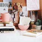 pink mug on stacked books